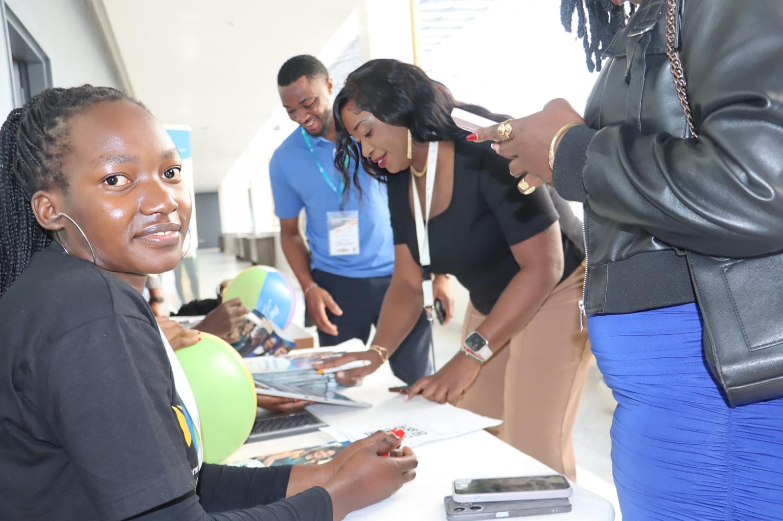Elimu staff reviewing student documents at a registration desk